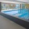 pool with sliding glass doors open to observation deck