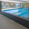 All season pool with sliding glass doors open to viewing deck